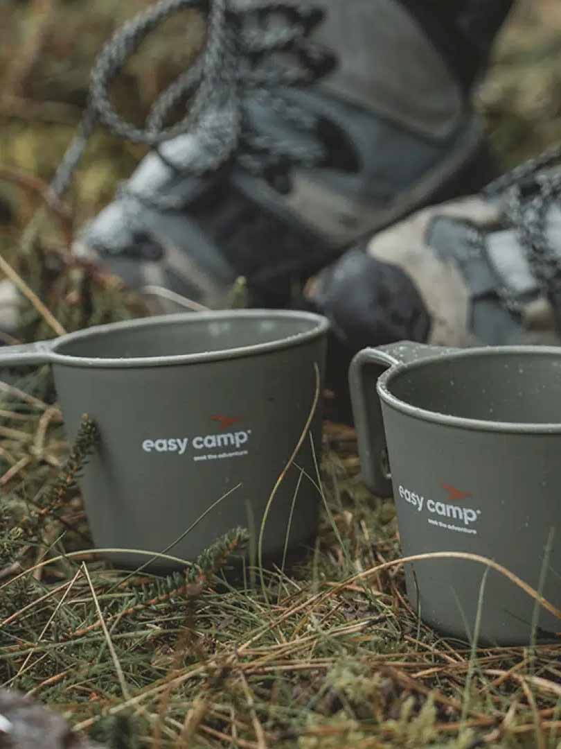 Varrio Sport outdoor gear with camping cups and hiking shoes.