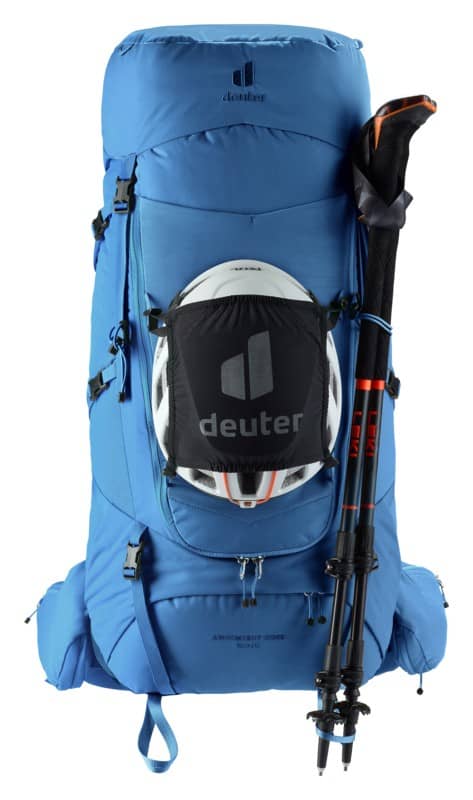 Голяма синя туристическа раница Deuter с каска и ски щеки.